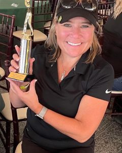 Asbury staff member holding a trophy